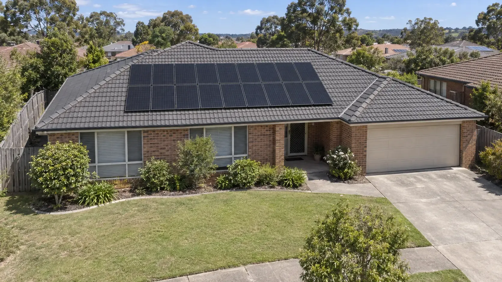 Solar panels beside unused roof space on a single-storey Australian brick home