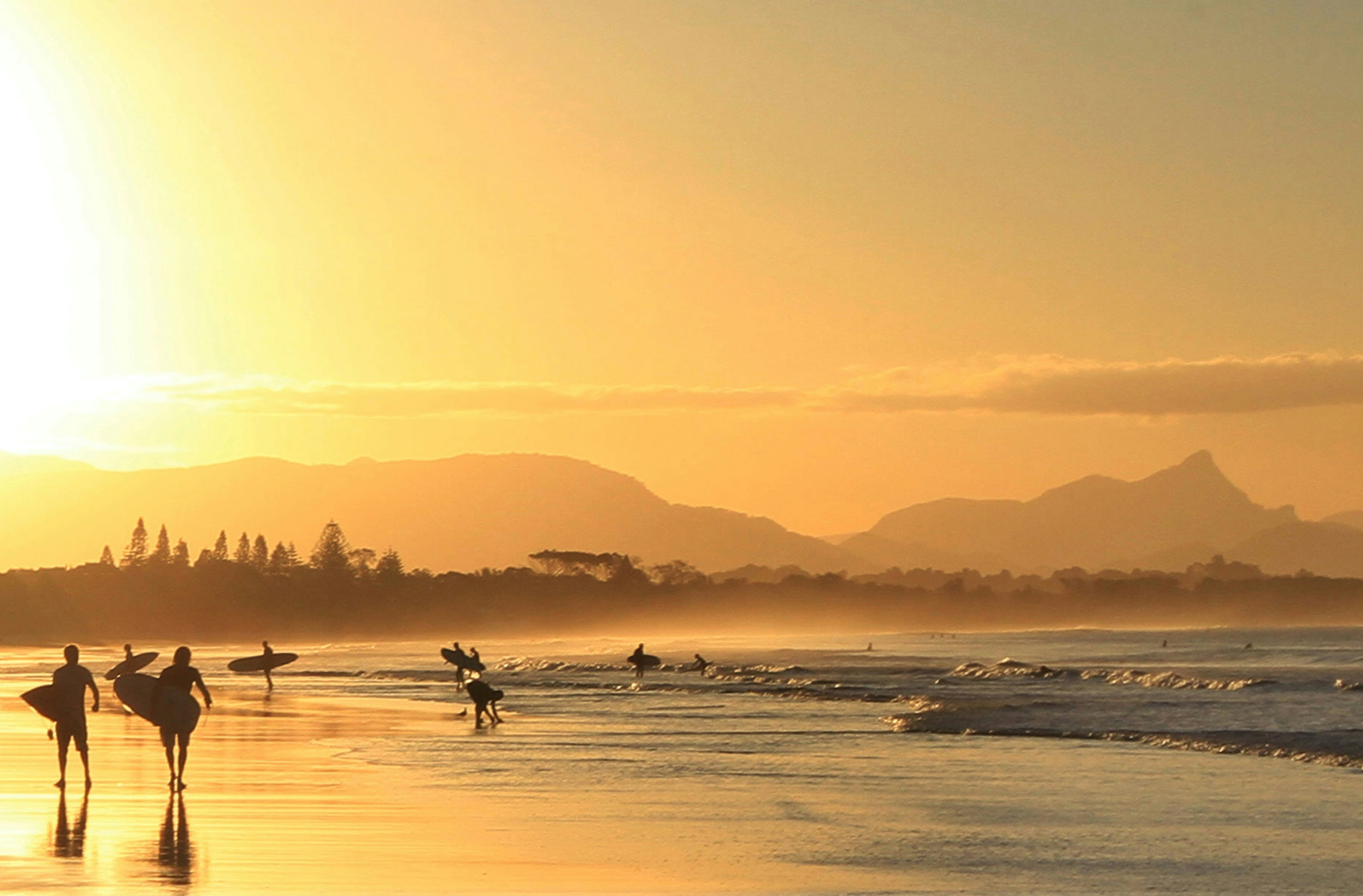 Byron bay surfers at sunset