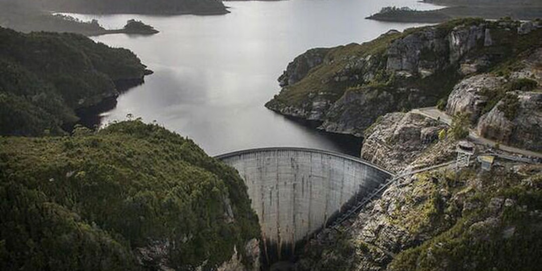 Tasmanian dam wall viewed from elevation on overcast day