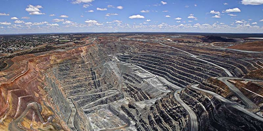 open cut coal mine with cloudy sky on horizon